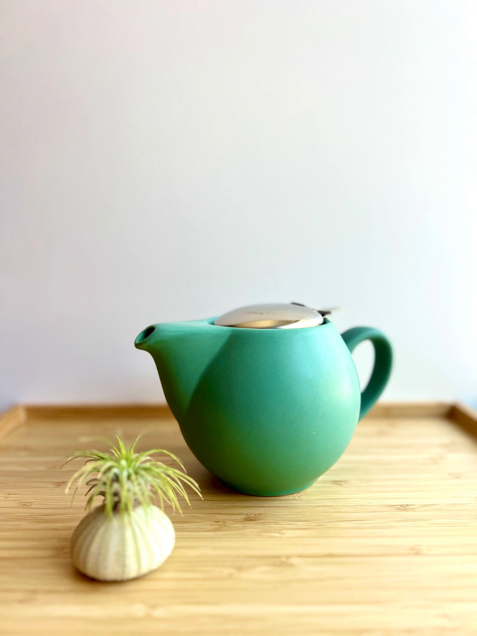 matte green teapot closed side view
